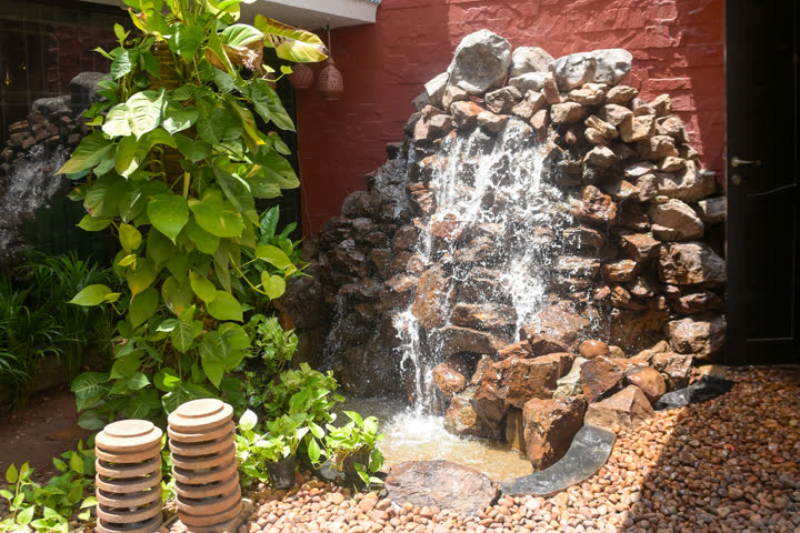 Courtyard waterfall in the recovery space at Visage by Dr Priti, Chennai