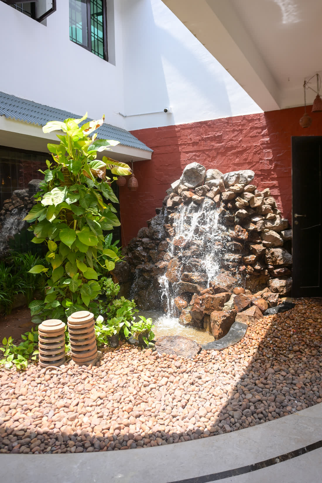 Courtyard waterfall in the recovery space at Visage by Dr Priti, Chennai